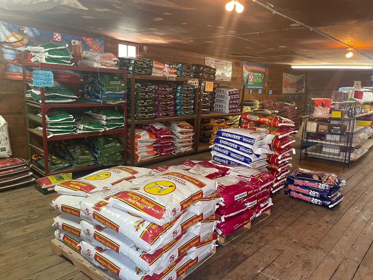 VICTOR and Hi-Point dog food bags stocked on the shelf alongside wild bird feed at Mustang Creek Feed Seed & Supply in Rio Vista, Texas