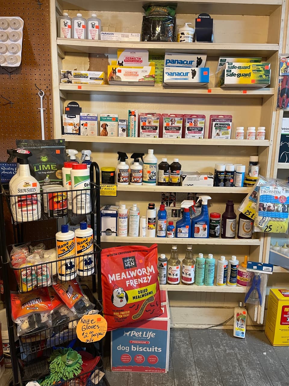 Mealworm Frenzy chicken treats, dewormers, and dog biscuits stocked on the shelf at Mustang Creek Feed Seed & Supply in Rio Vista, Texas