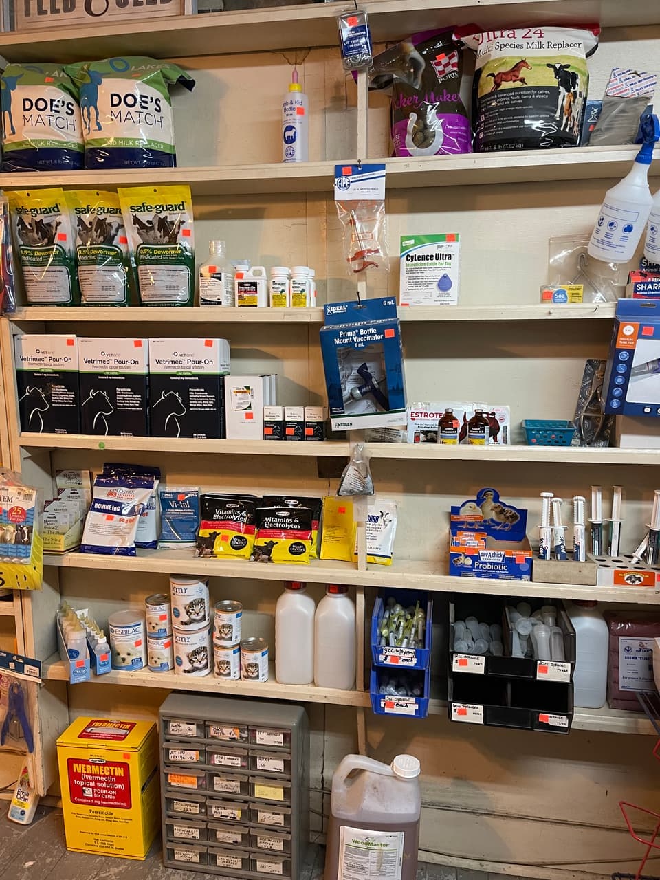 Goat kid milk replacer, dewormers, and vitamin and electrolyte supplements stocked on the shelf at Mustang Creek Feed Seed & Supply in Rio Vista, Texas