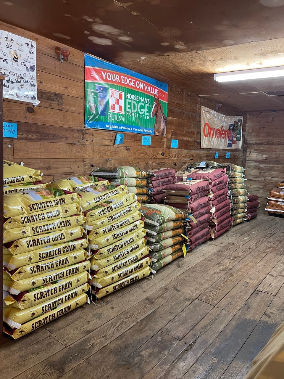 Big Buck 20% protein deer feed pellets stocked alongside Golden Oak grain ahead of hunting season at Mustang Creek Feed Seed & Supply