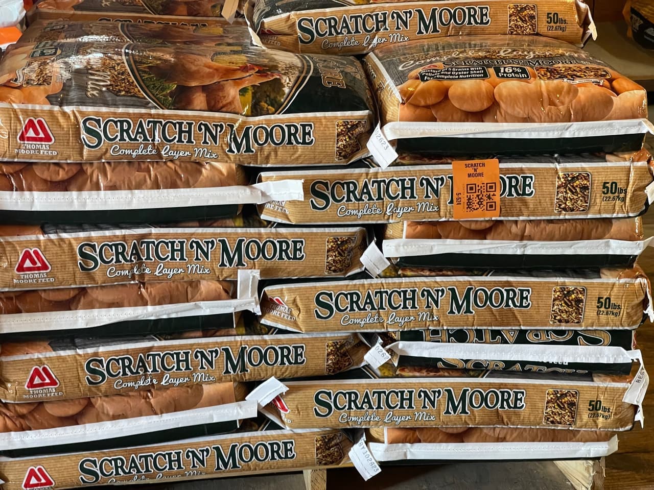 Pallets of Scratch N' Moore complete layer mix poultry feed stocked at Mustang Creek Feed Seed & Supply in Rio Vista, Texas