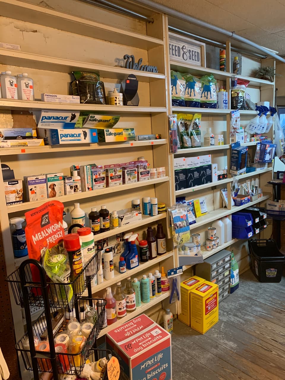 Dewormers, fly spray, and animal health supplies stocked on the shelf at Mustang Creek Feed Seed & Supply in Rio Vista, Texas